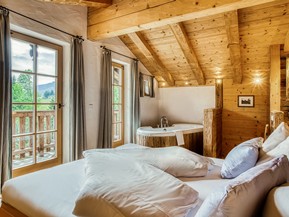 Bedroom with Freestanding Bathtub at the Private Spa Chalet Honeymoon at Naturresort Puradies Bedroom with freestanding bathtub at the Private Spa Chalet Honeymoon at Naturresort Puradies