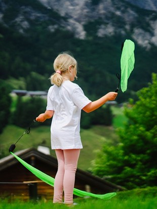 Child with Juggling Scarves During Circus Week at Naturresort Puradies, Leogang, Salzburger Land Child with green juggling scarves, Puradies Leogang