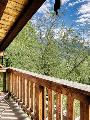 Balcony with Deck Chair and Nature View at the Private Spa Chalet Honeymoon at Naturresort Puradies Balcony with deck chair and nature view at the Private Spa Chalet Honeymoon at Naturresort Puradies