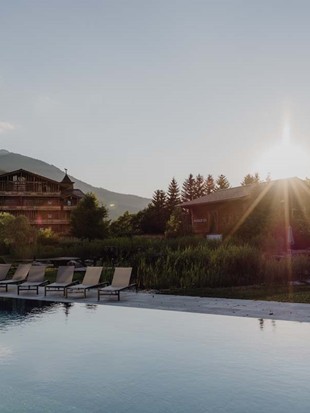 Infinity Pool at the Heaven Spa at Sunset with Traumquartier and Sauna House in the Background, Naturresort Puradies, Leogang, Salzburger Land Infinity Pool at the Heaven Spa at sunset with Traumquartier and Sauna House in the background, Puradies Leogang
