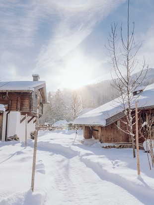 Snow-Covered Chalets in Winter Sunshine – Naturresort Puradies, Leogang, Salzburger Land Snow-covered chalets in winter sunshine, Puradies Leogang
