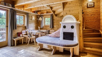 Wohnbereich mit Kachelofen im Privat Spa Chalet Honeymoon im Naturresort Puradies