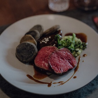 Rosa gebratenes Fleisch mit Brokkoli und Sauce, Naturresort Puradies, Leogang, Salzburger Land Rosa gebratenes Fleisch mit Brokkoli auf weißem Teller, Puradies Leogang