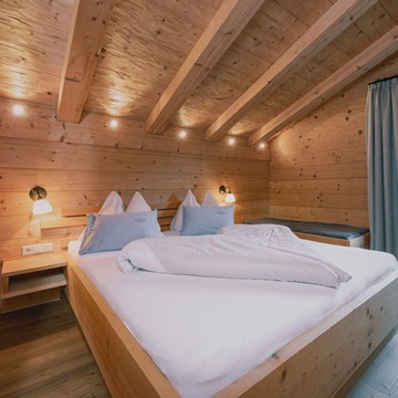 Bedroom in the Chalet at Puradies in Winter, Naturresort Puradies, Leogang Bedroom in the chalet at Naturresort Puradies in winter