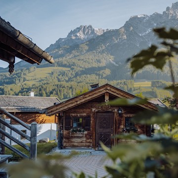 Chalets with Mountain Panorama Framed by Green Foliage, Naturresort Puradies, Leogang, Salzburger Land Chalets with mountain panorama framed by foliage, Puradies Leogang