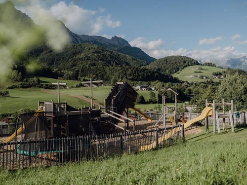 Abenteuerspielplatz mit Trampolin und Bergpanorama im Naturresort Puradies, Leogang, Salzburger Land Abenteuerspielplatz mit Trampolin vor Bergpanorama, Puradies Leogang