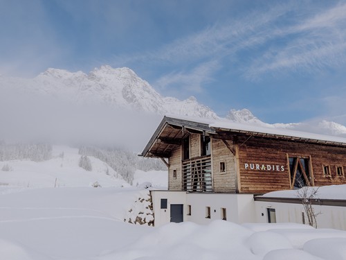 Saunahaus im Schnee vor Bergpanorama, Puradies Leogang