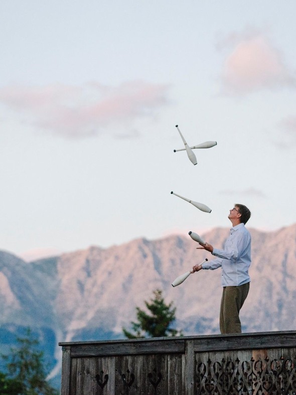 Juggling Clubs on the Event Chalet Terrace at Naturresort Puradies, Leogang, Salzburger Land Person juggling clubs on Event Chalet terrace, Puradies Leogang